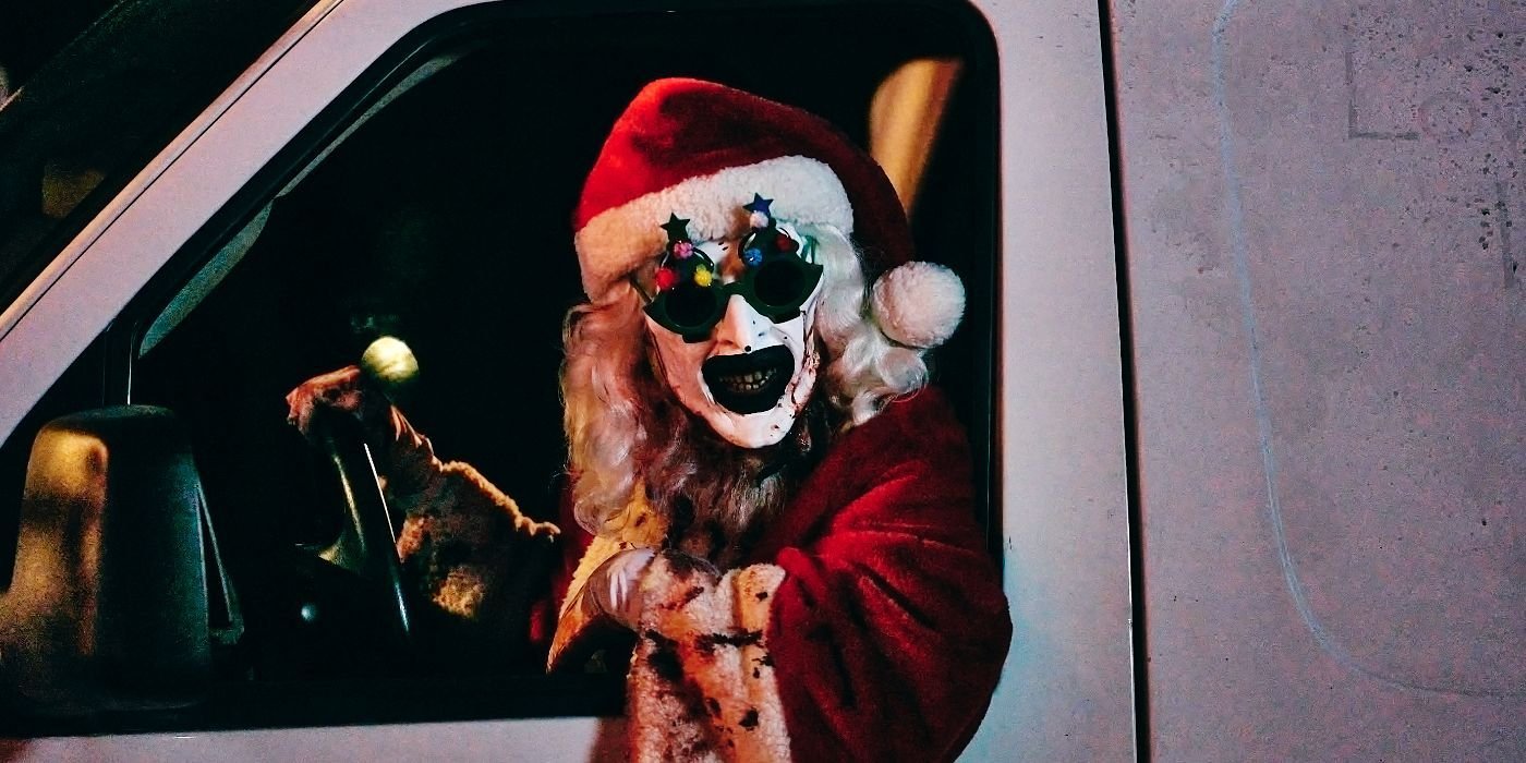 Art the Clown (David. Howard Thornton) wearing a santa suit and leaning out of a van in Terrifier 3.