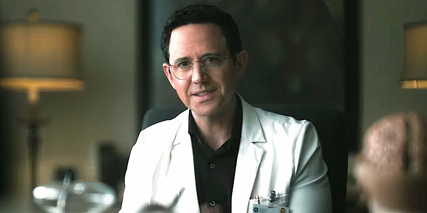 Santino Fontana's dream specialist sits at a desk in Grotesquerie episode 8