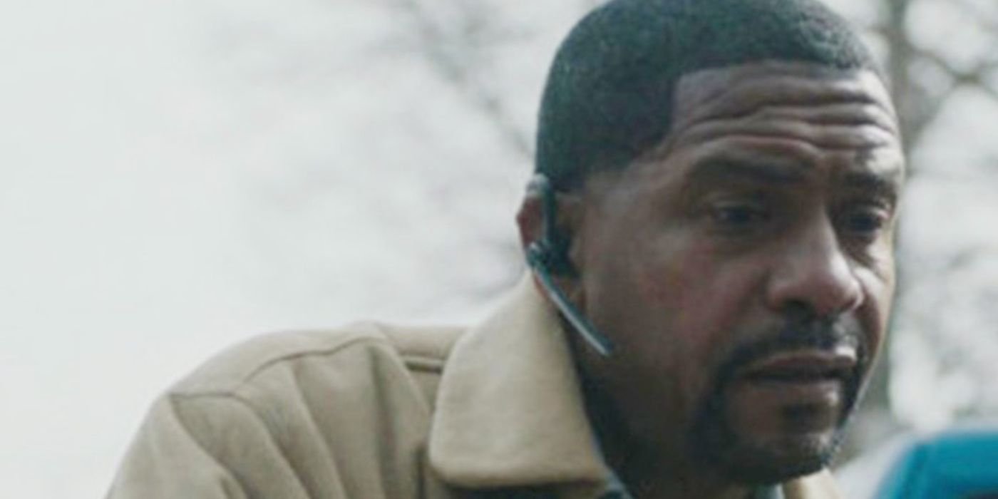 Rolando Boyce as Darnell The Chi speaking on a headset in The Chi.
