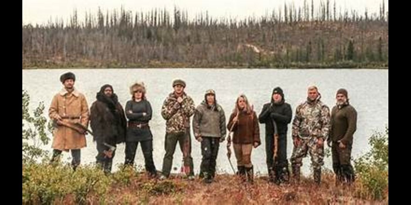 cast posing on alone history channel in front of water and forest