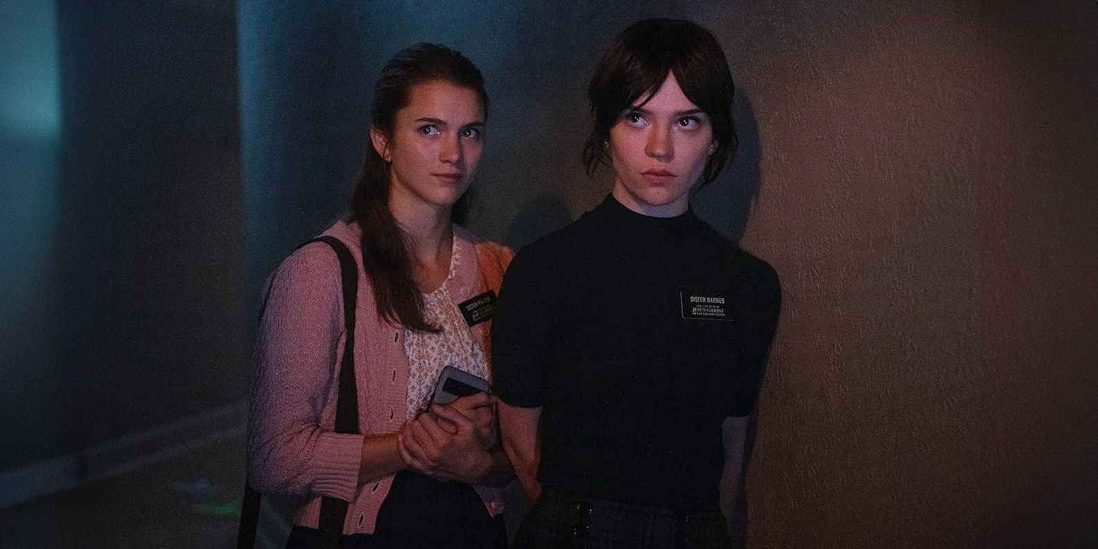 Sister Barnes and Sister Paxton carefully walk through a hallway in Heretic