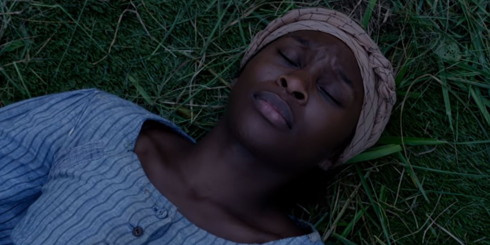 Cynthia Erivo as Harriet Tubman lying in the grass in Harriet