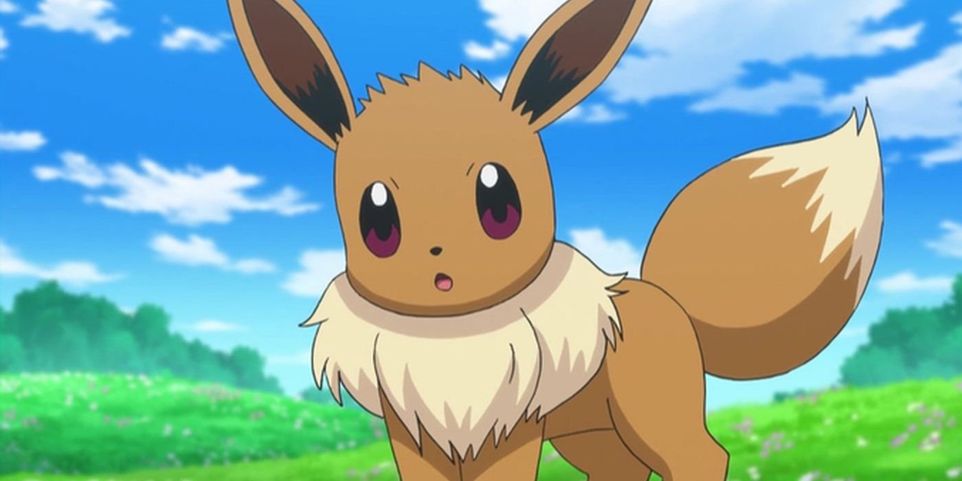 Eevee, a brown fox-like Pokemon, standing on green grass looking at the camera with a confused look on its face