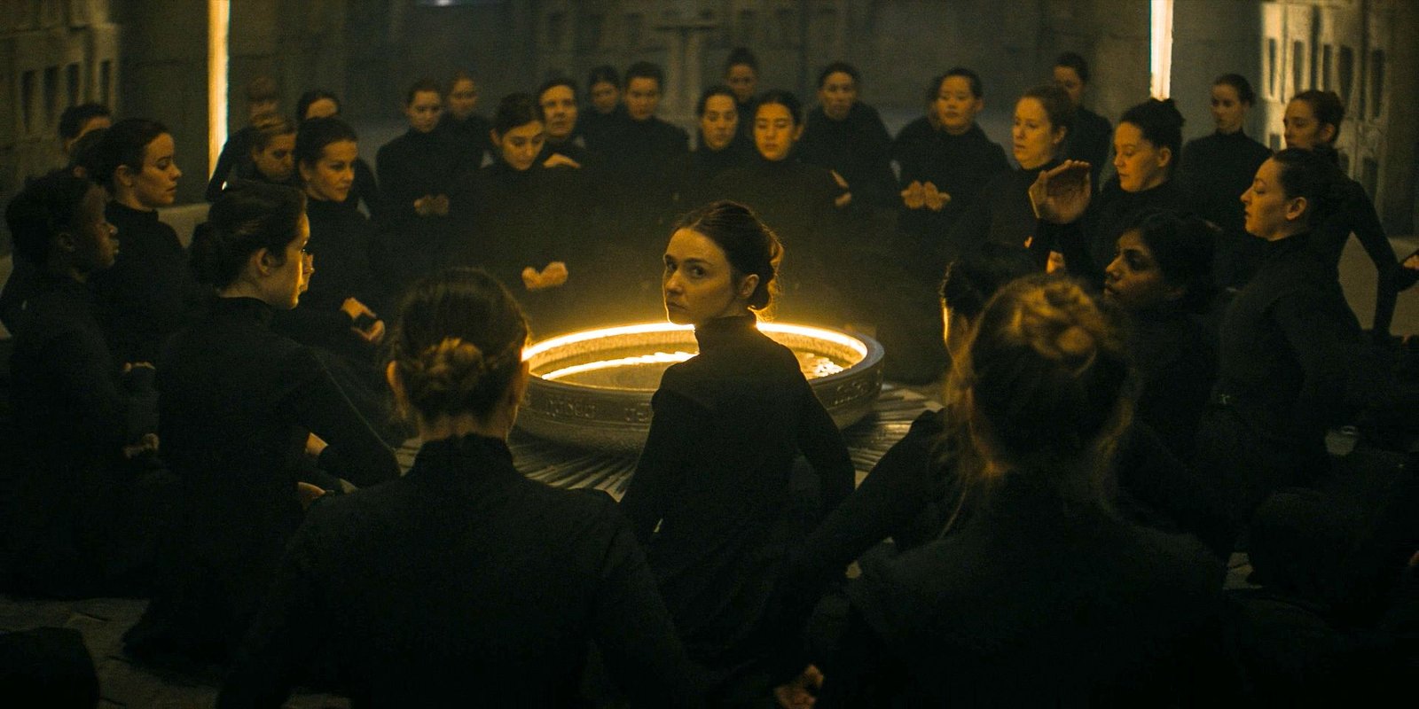 Young Valya Harkonnen (Jessica Barden) looking over her shoulder, surrounded by the Sisterhood in Dune: Prophecy Season 1 Ep 1