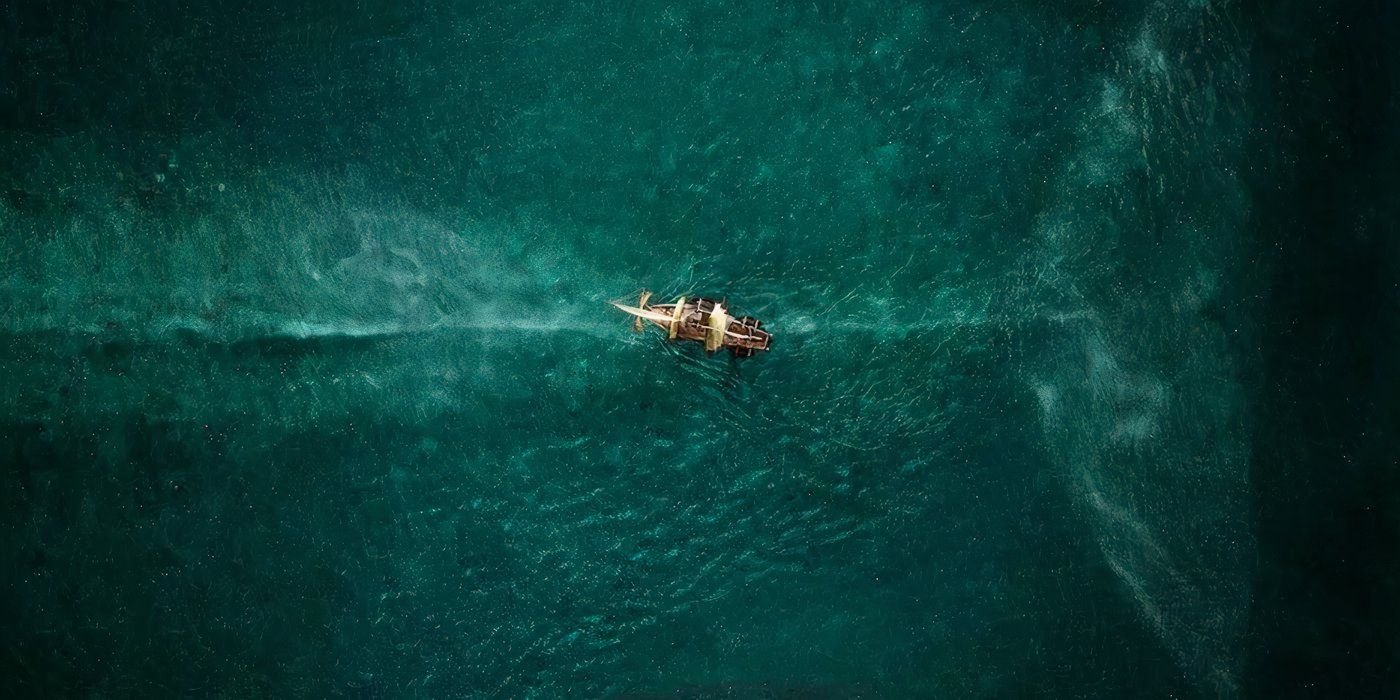 A whale swims under a tiny boat, In the Heart of the Sea