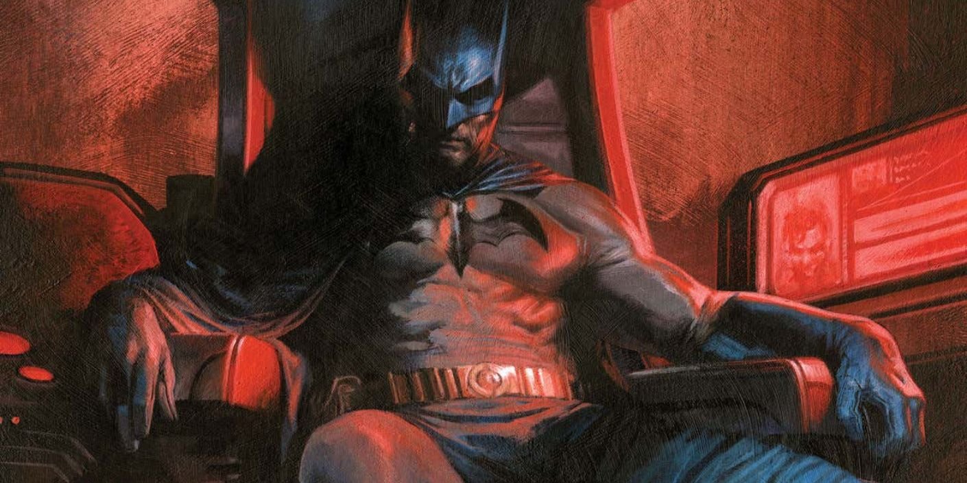  Batman sitting in his chair in the batcave