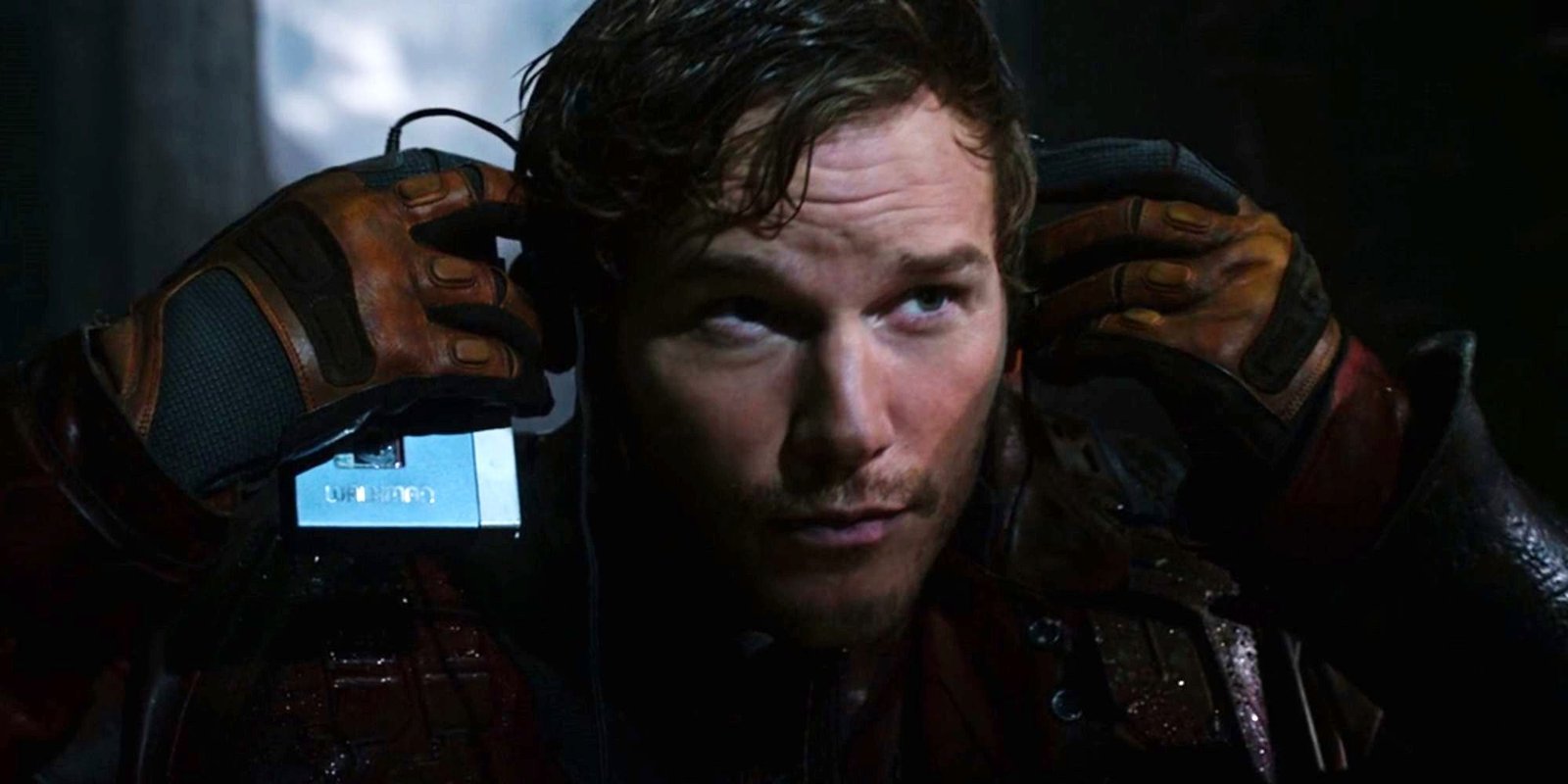 Chris Pratt as Star-Lord putting on headphones to listen to the Awesome Mix in Guardians of the Galaxy