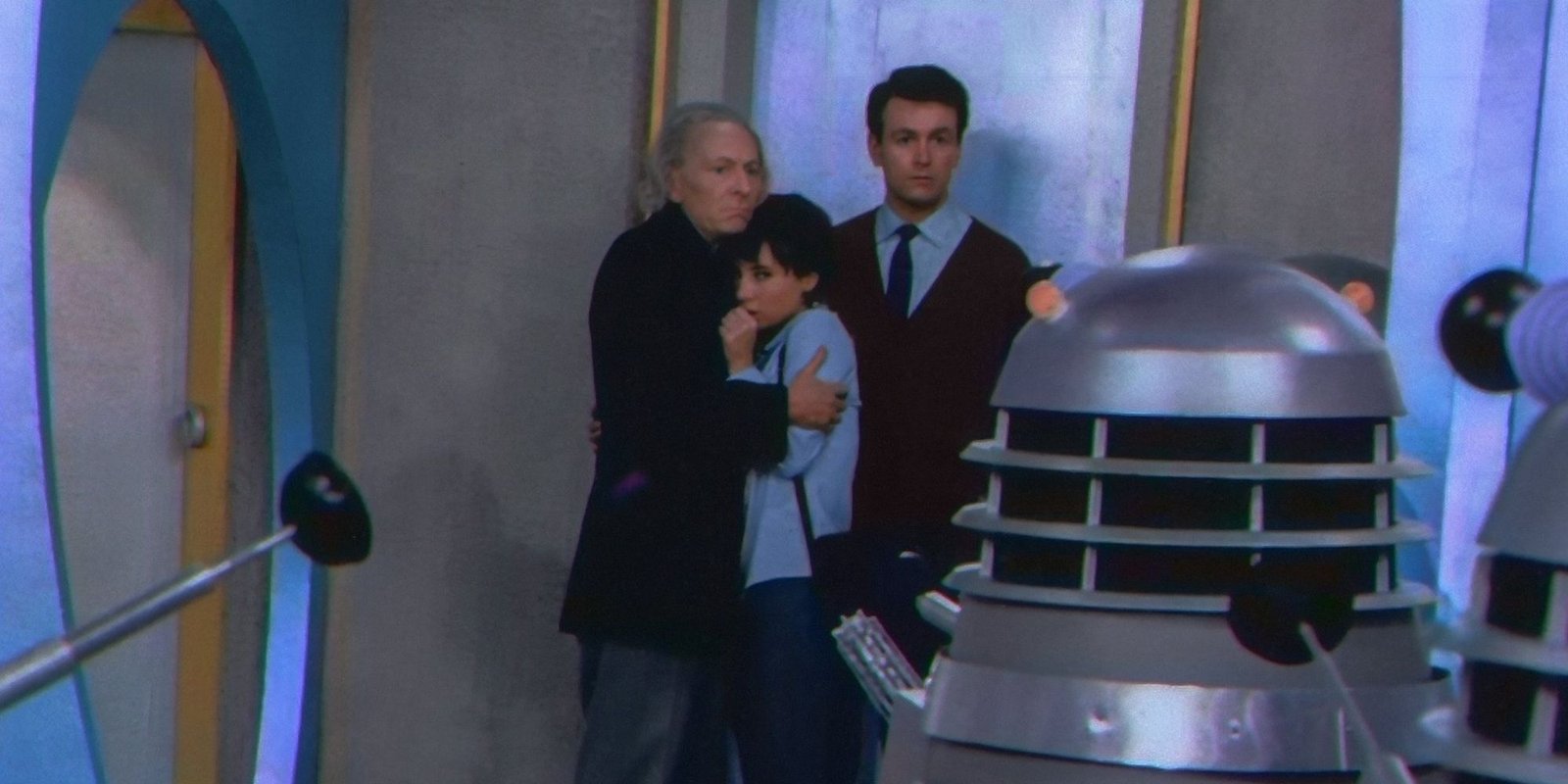 The First Doctor, Susan, and Ian all cowering from Daleks in Doctor Who.