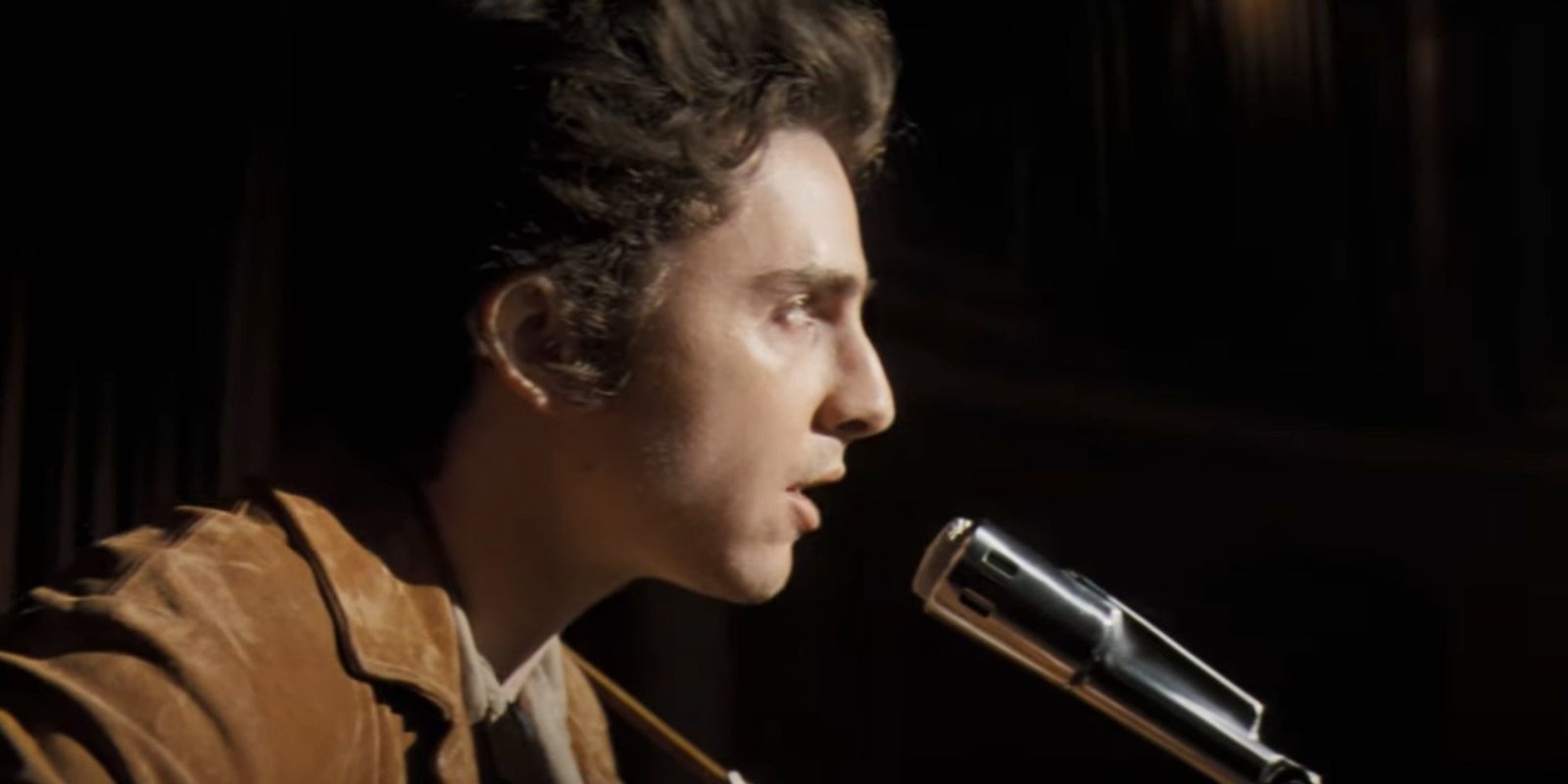 Timothee Chalamet as Bob Dylan singing in A Complete Unknown