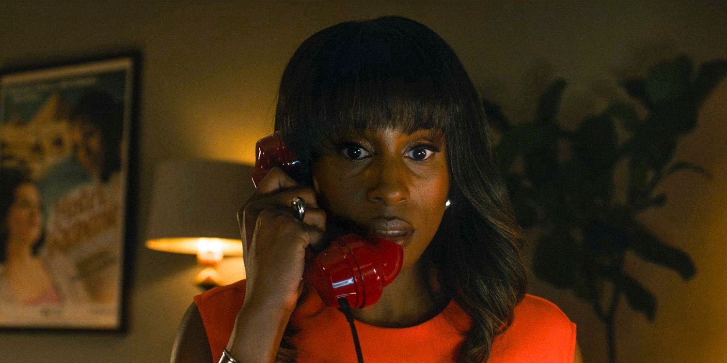 Brandy (Issa Rae) talking on a red rotary phone in Black Mirror season 7, episode 3, "Hotel Reverie"