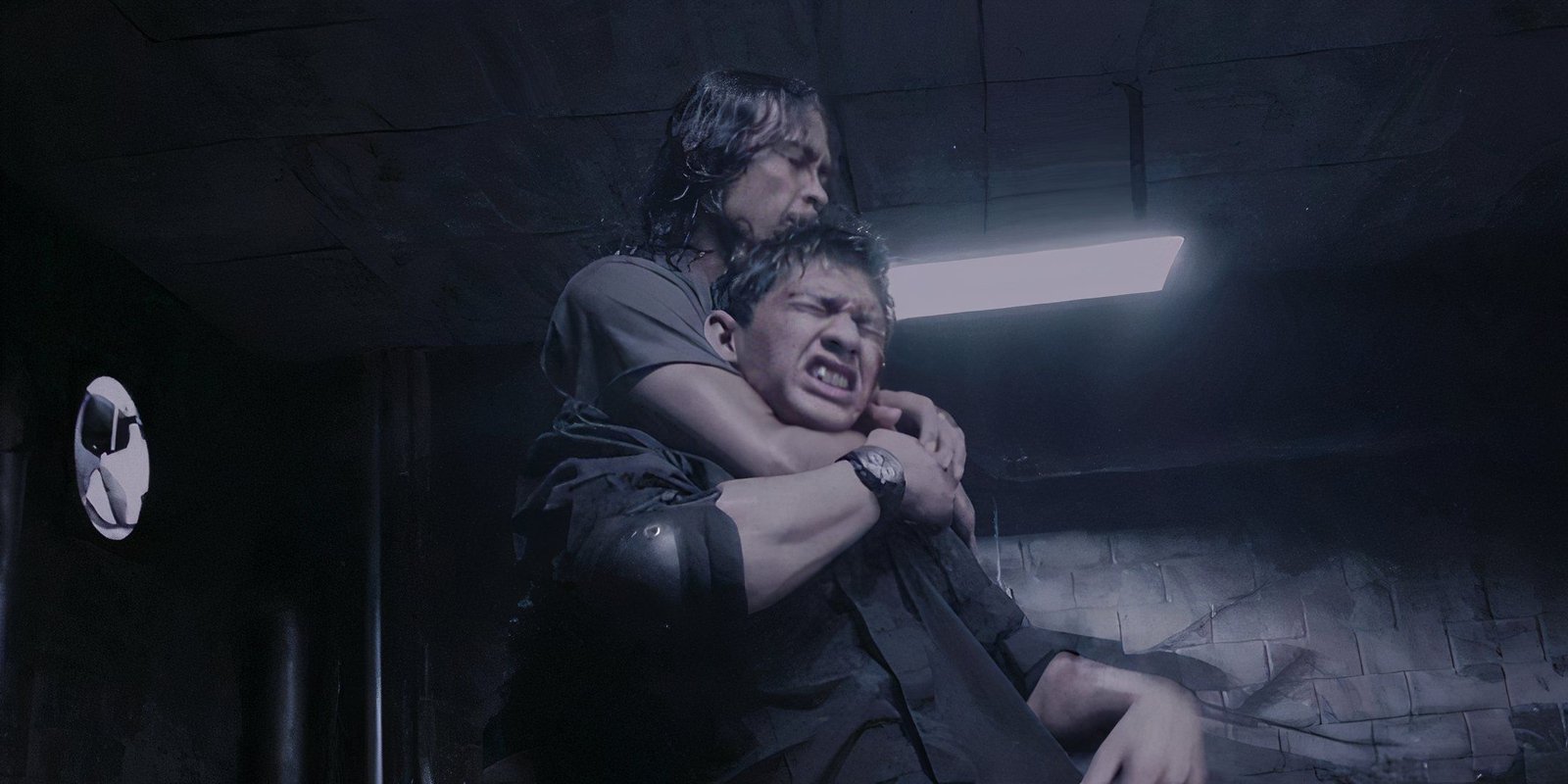 Iko Uwais getting choked out by an attacker in The Raid