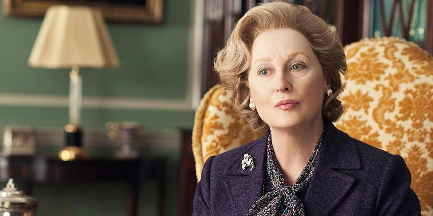 meryl streep as margaret tatcher sitting a couch in The Iron Lady