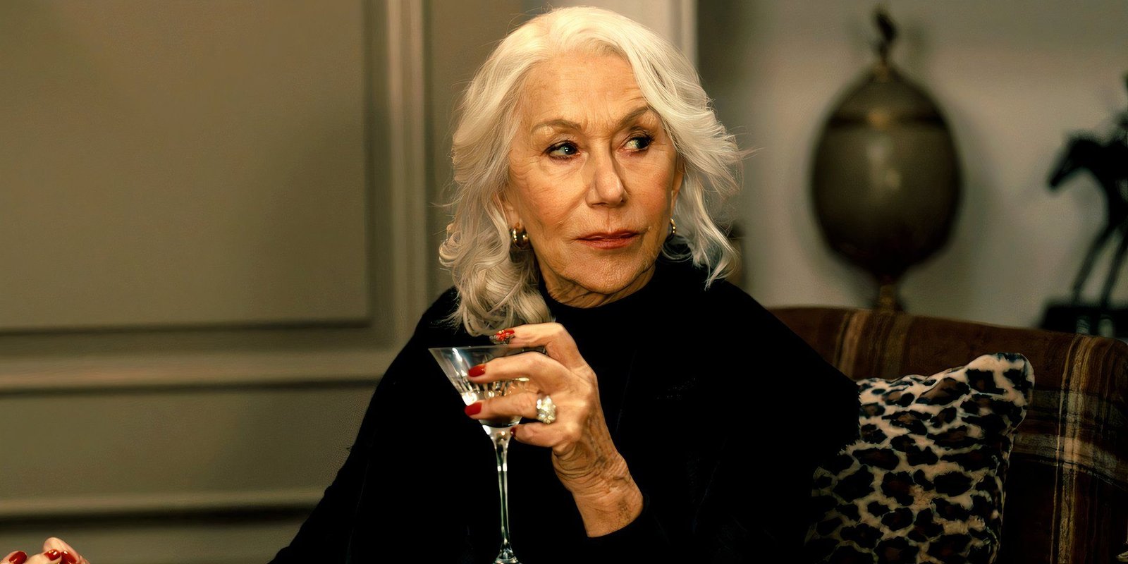 Helen Mirren holding a glass martini in MobLand