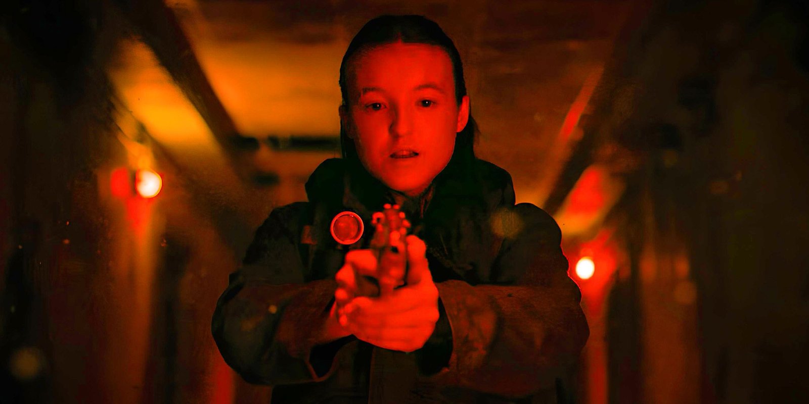 Bella Ramsey as Ellie in the Last of us Season 2 Pointing a Gun in the basement of a hospital