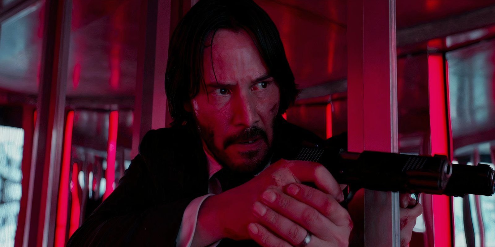 Keanu Reeves points a gun as John Wick in a hall of mirrors in John Wick: Chapter 2