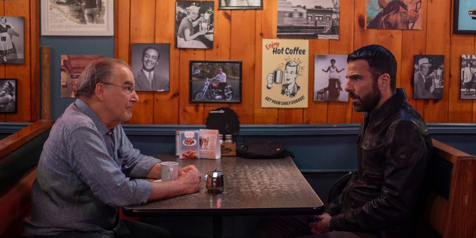 Brilliant Minds Wolf sitting across from Noah in a diner looking skeptical