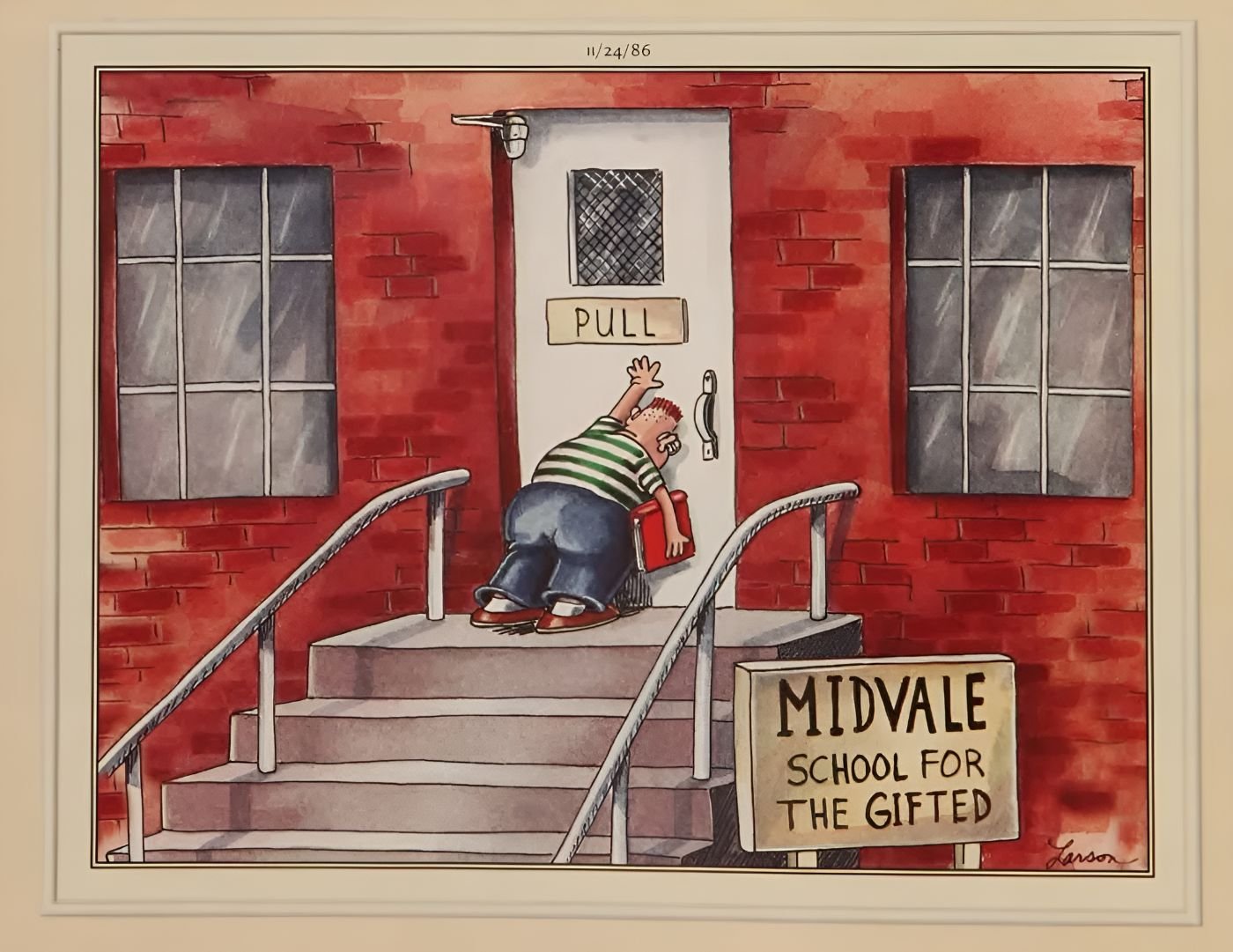 A child at a "gifted" school attempts to push on a "PULL" sign.