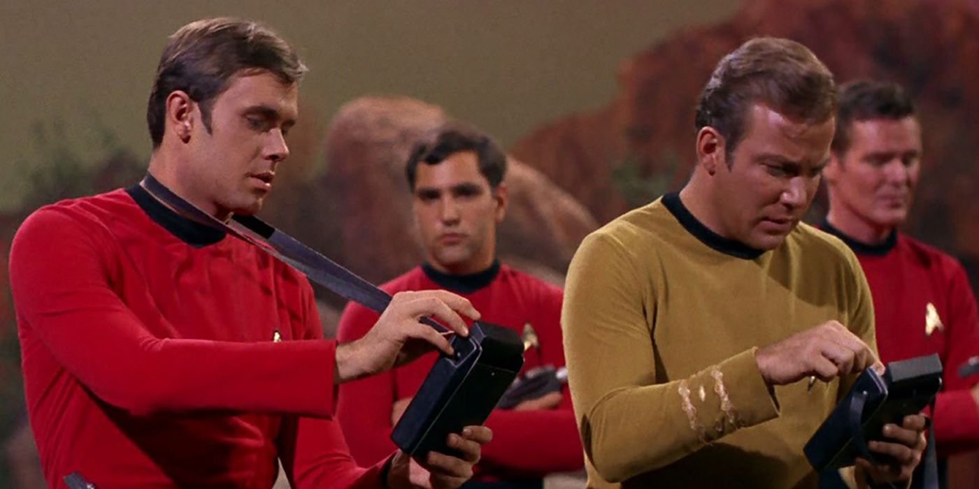 A redshirt and William Shatner's Kirk check their tricorders in Star Trek: The Original Series.