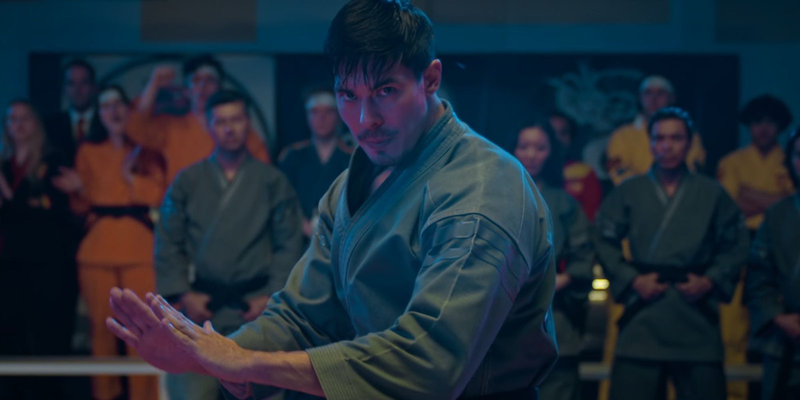 Lewis Tan in a fighting stance as Sensei Wolf in Cobra Kai
