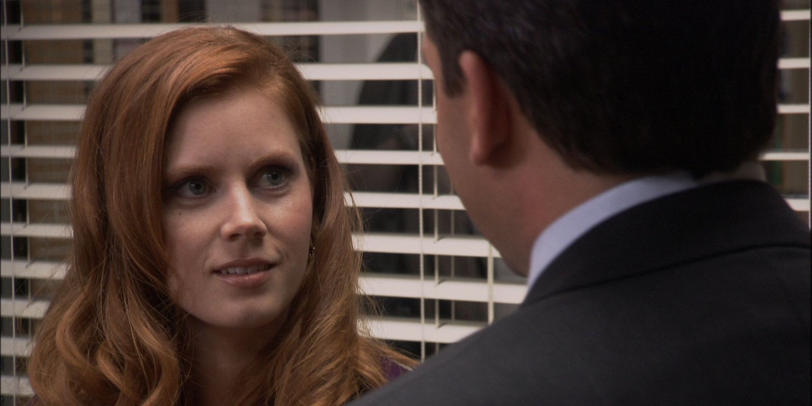 Amy Adams as Katy looking at Michael Scott as they have an awkward chat in the conference room in The Office season 1 episode "Hot Girl."