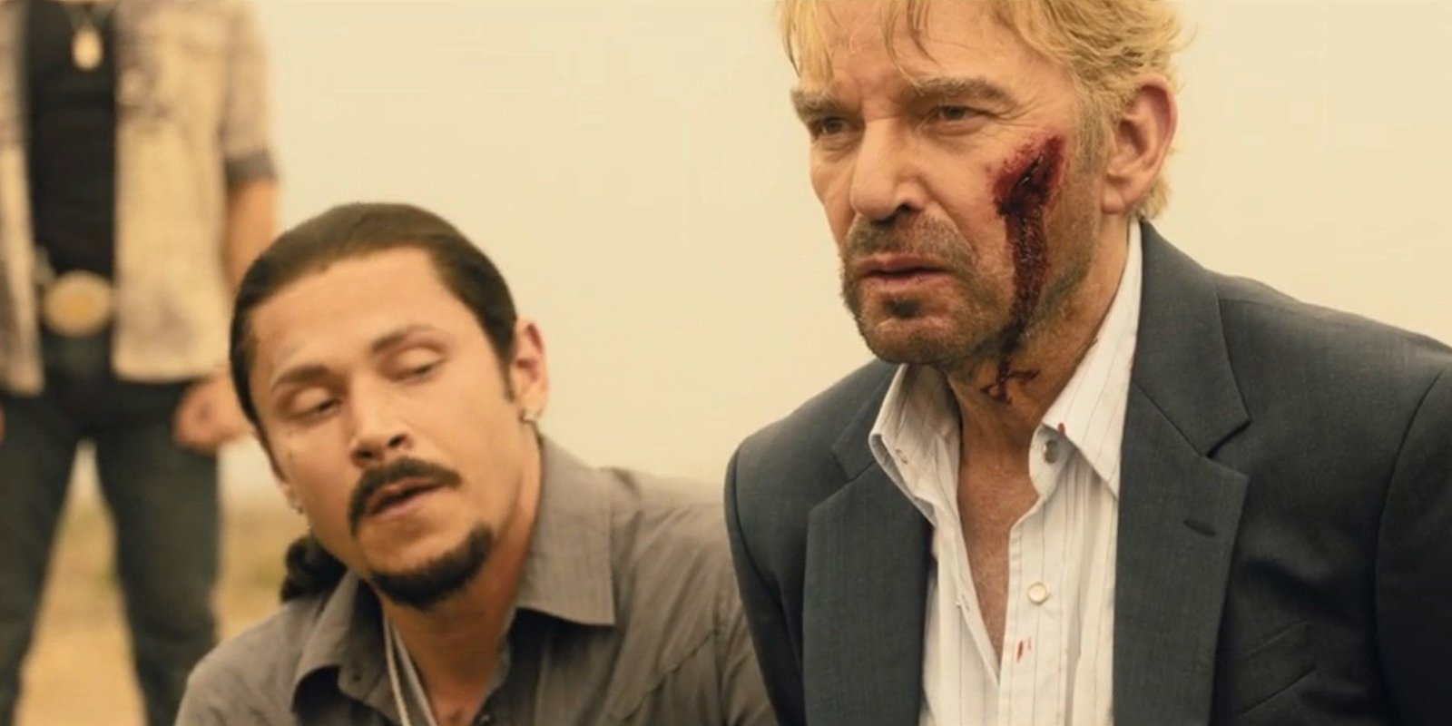 Jimenez (Alex Meraz) kneeling behind Tommy Norris (Billy Bob Thornton) in Landman season 1, episode 10