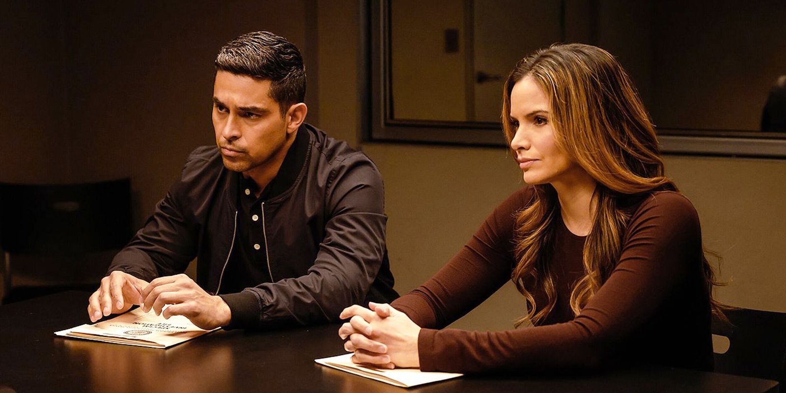NCIS Season 23's Story Plan Confirms 1 Unexpected Reality About Mark Harmon's Gibbs Prequel 2 Wilmer Valderrama's Nick Torres and Katrina Law's Jessica Knight sitting at an interrogation table in NCIS