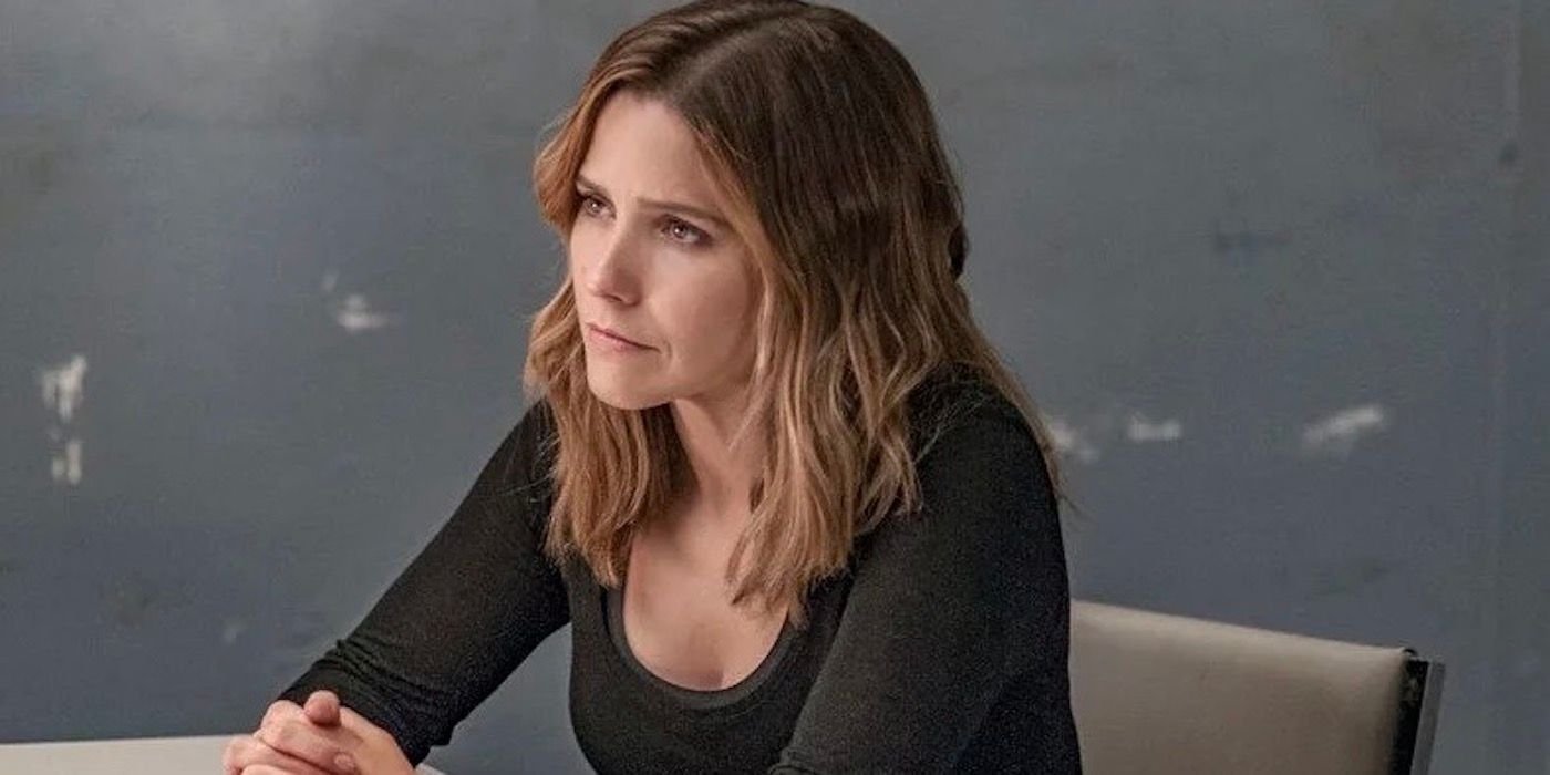 Erin Lindsay sitting at interrogation table with hands interlocked in Chicago PD