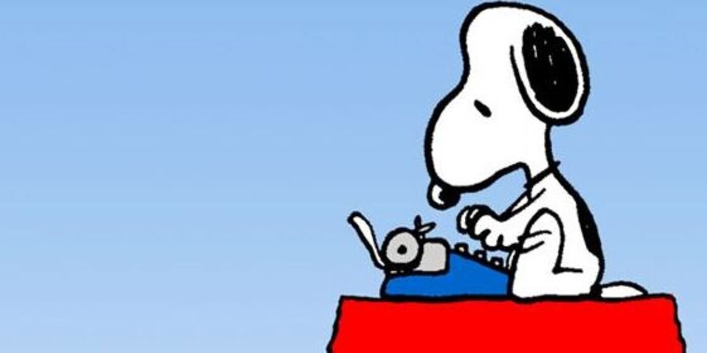 Snoopy writing on his typewriter on his doghouse.