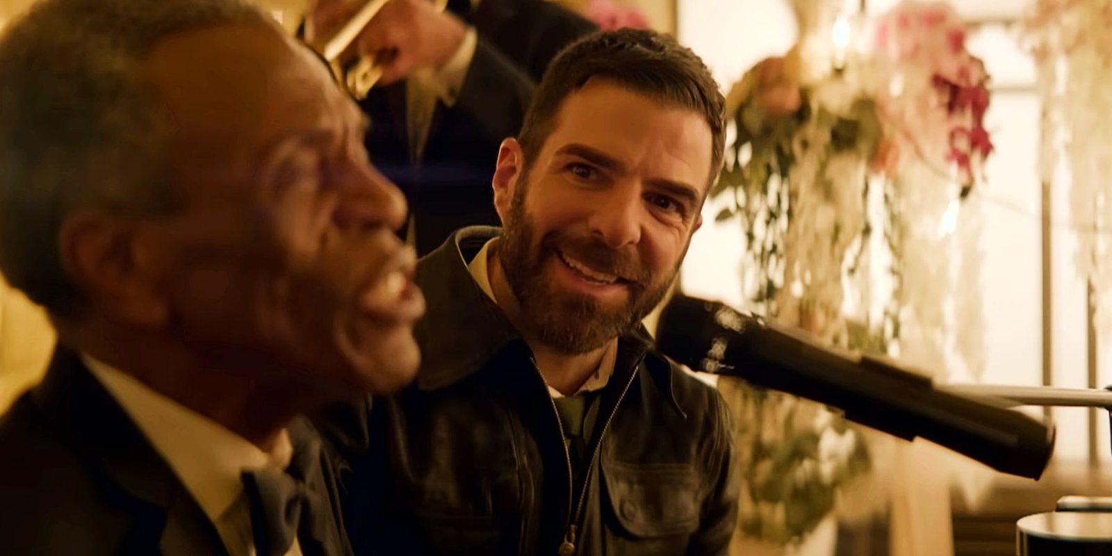 Zachary Quinto smiles as a patient sings in Brilliant Minds
