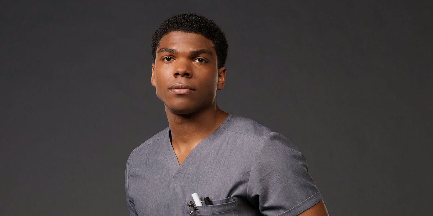 Spence Moore II poses in front of a grey backdrop in Brilliant Minds