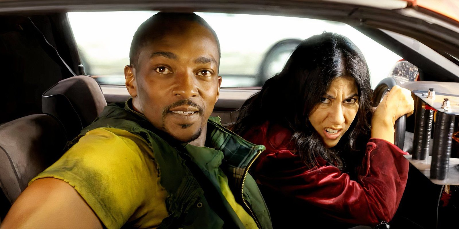 Anthony Mackie smiling while Stephanie Beatriz drives the car in Twisted Metal