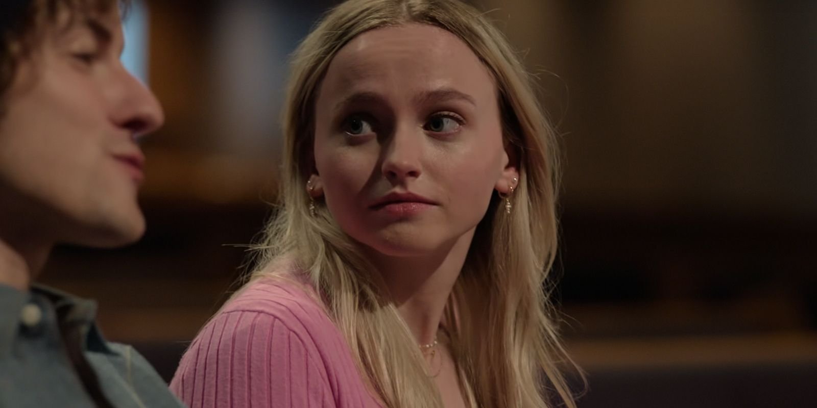 Abby looks to the side at Pastor Pete in The Hunting Wives season 1