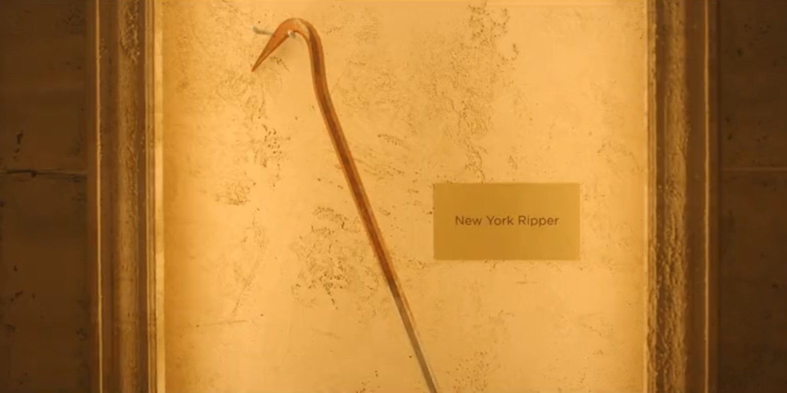 A long hooked tool with a placard that reads "New York Ripper" in Leon Prater's museum in Dexter: Resurrection season 1, episode 4