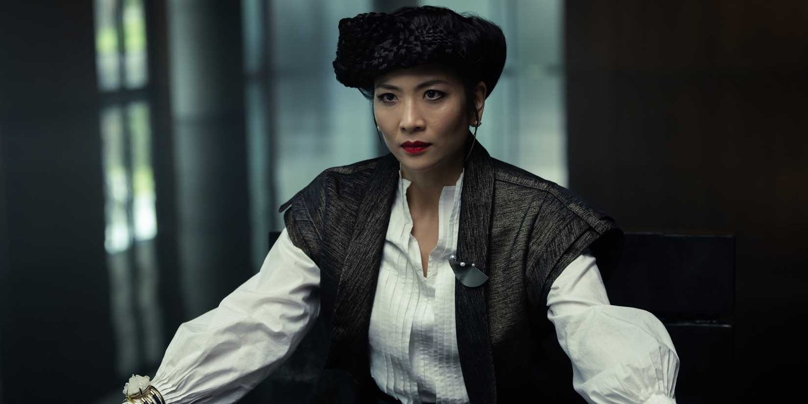 Yutani (Sandra Yi Sencindiver) looking irate while wearing an ornate outfit and hat in Alien: Earth