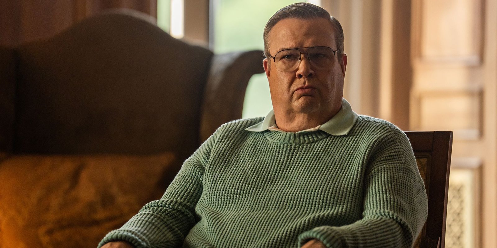 Eric Stonestreet as Al looking terse while sitting in a chair in Dexter: Resurrection