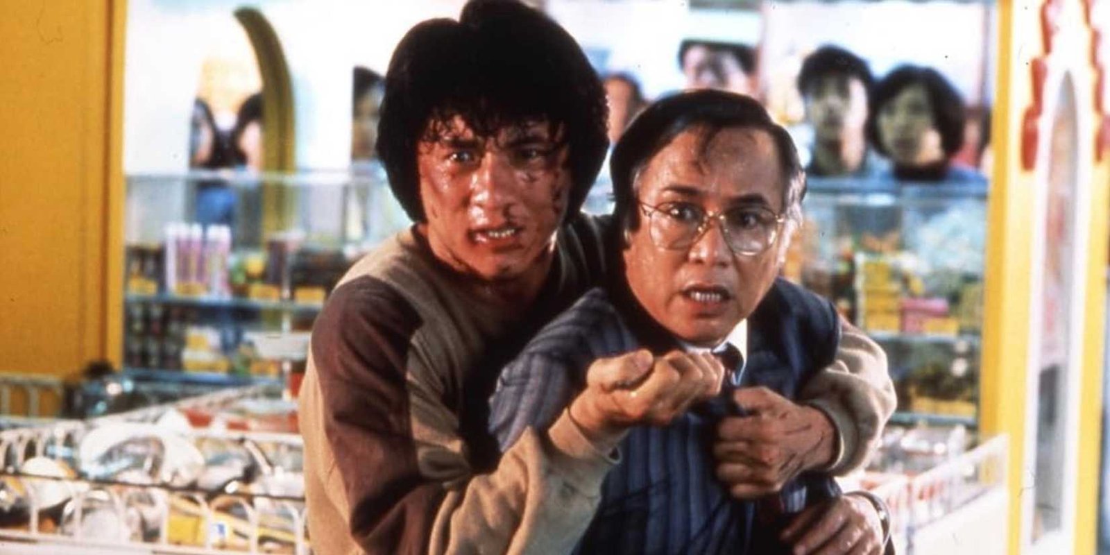 Jackie Chan holds Yuen Chor out in front of him. 