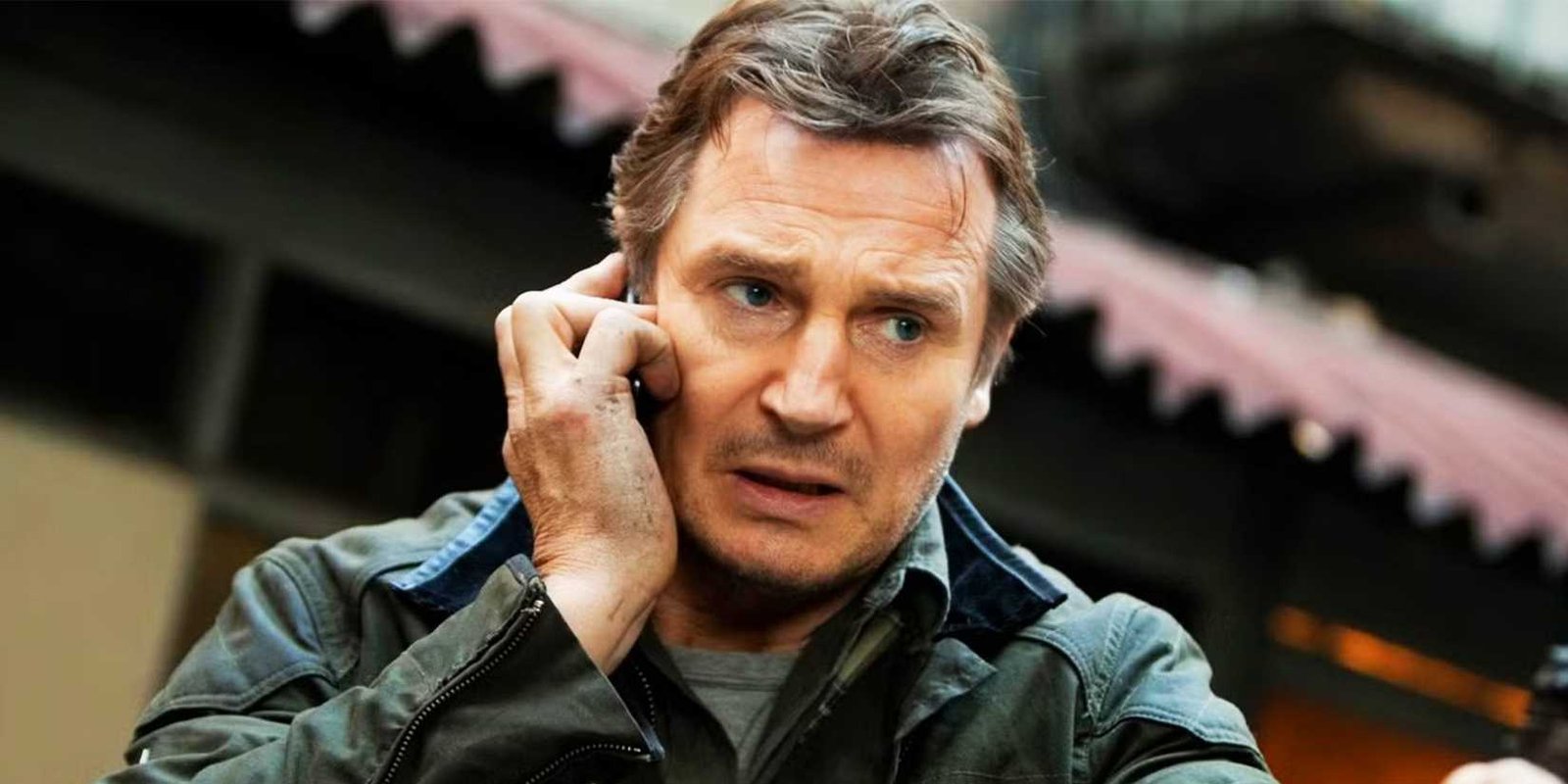 Liam Neeson talking to someone in Taken