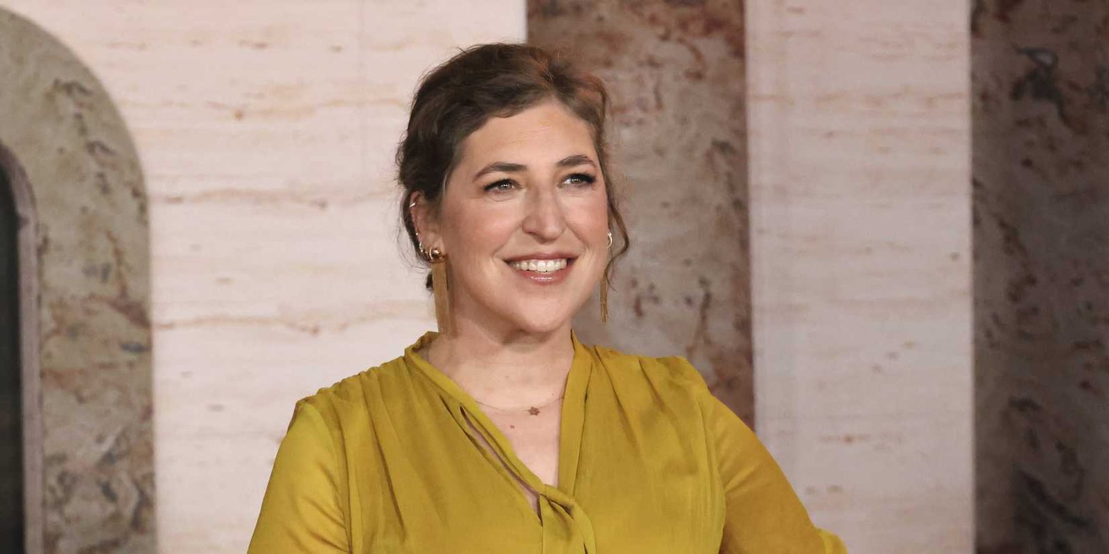 Mayim Bialik smiling on the red carpet