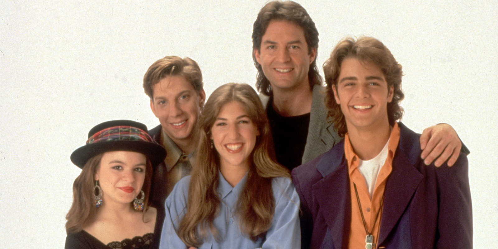 The cast of Blossom pose together while smiling against a white background 