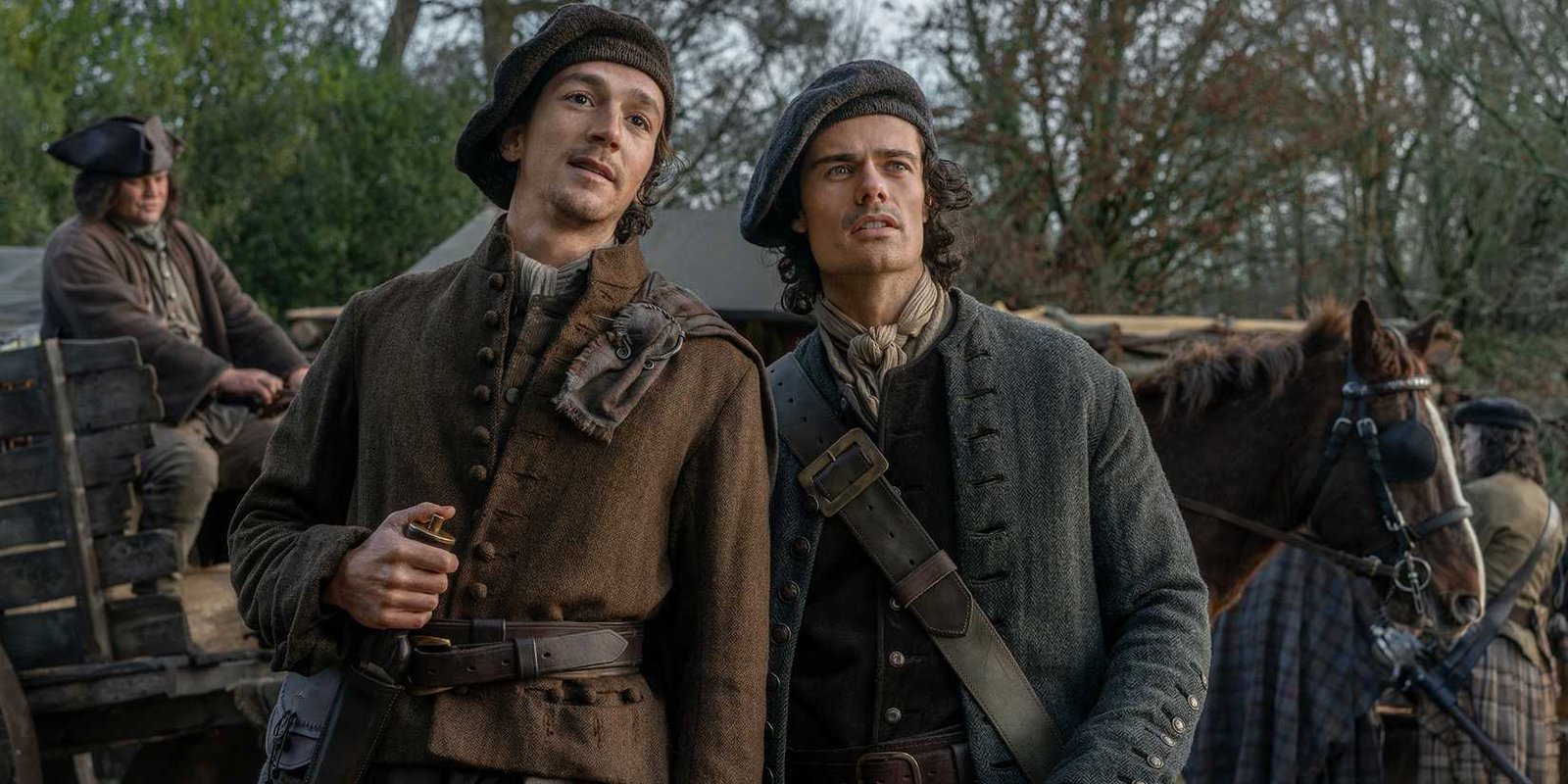 Rory Alexander's Murtagh and Jamie Roy's Brian looking curious while standing in front of a carriage in Outlander: Blood of My Blood