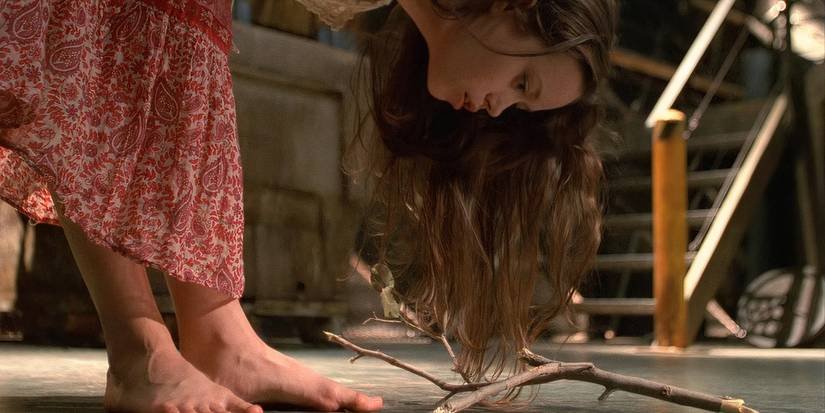Summer Glau as River Tam in bending over and looking at a branch on the ground in the Firefly finale.